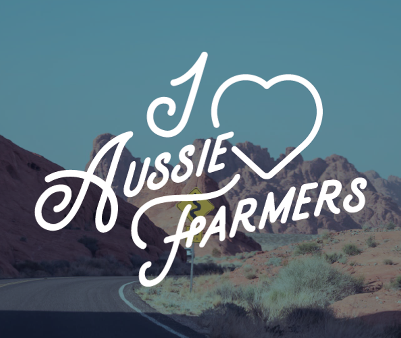 I Love Aussie Farmers text against a mountain background