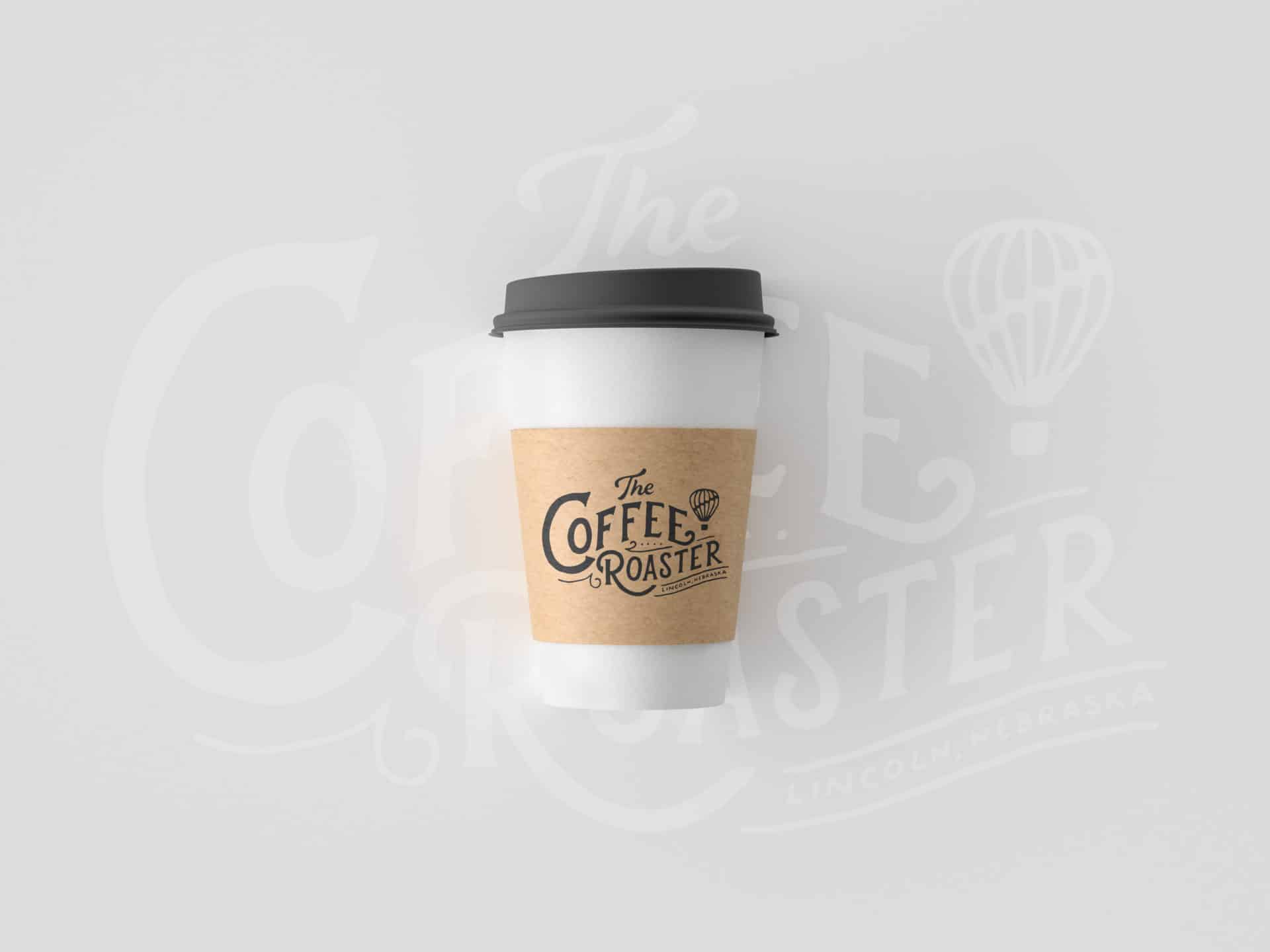 Coffee Roaster branded coffee cup in front of hand-lettered background